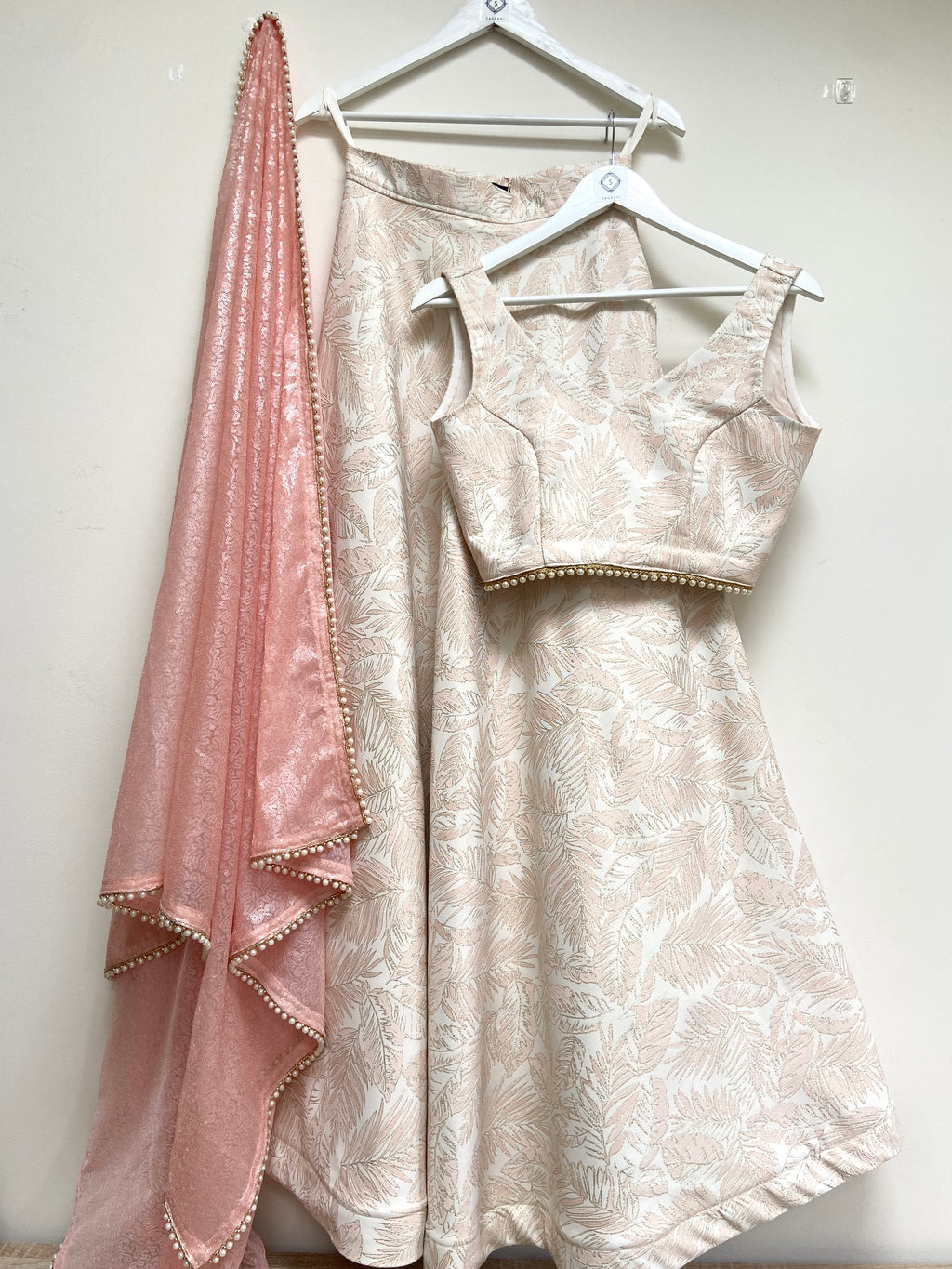 Pink and cream leaf brocade lehenga set with beaded trim